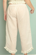 Cotton ruffle capri with 1" elastic back waist and asymmetrical contrast ruffle hem.
